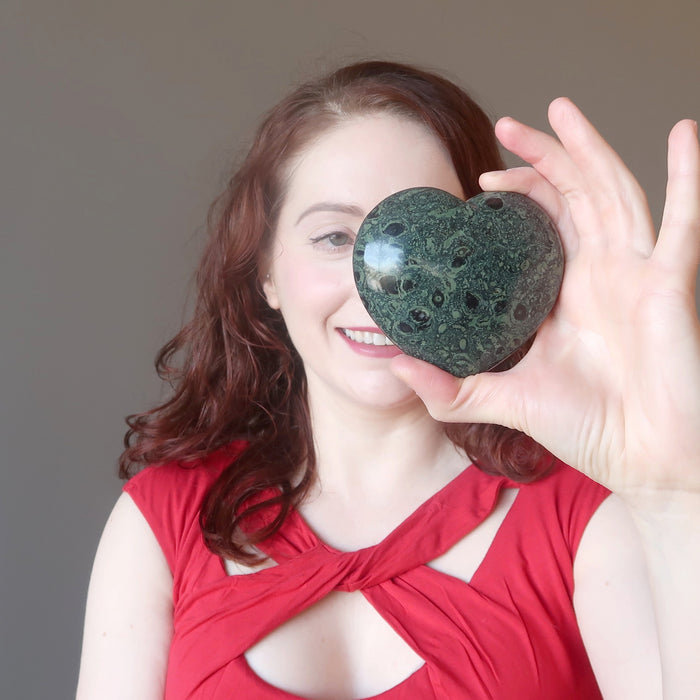 woman gazing into kambaba jasper heart