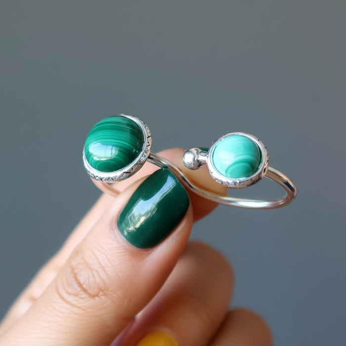 hand holding malachite double knuckle duster ring