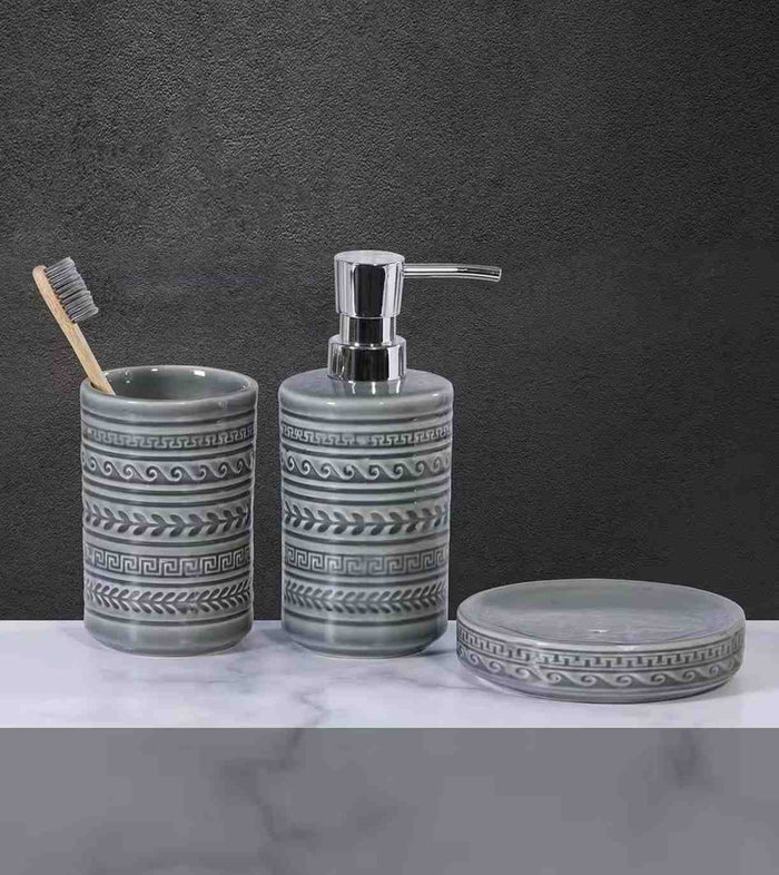 Gray ceramic bathroom accessory set with chrome pump, patterned tumbler, and soap tray