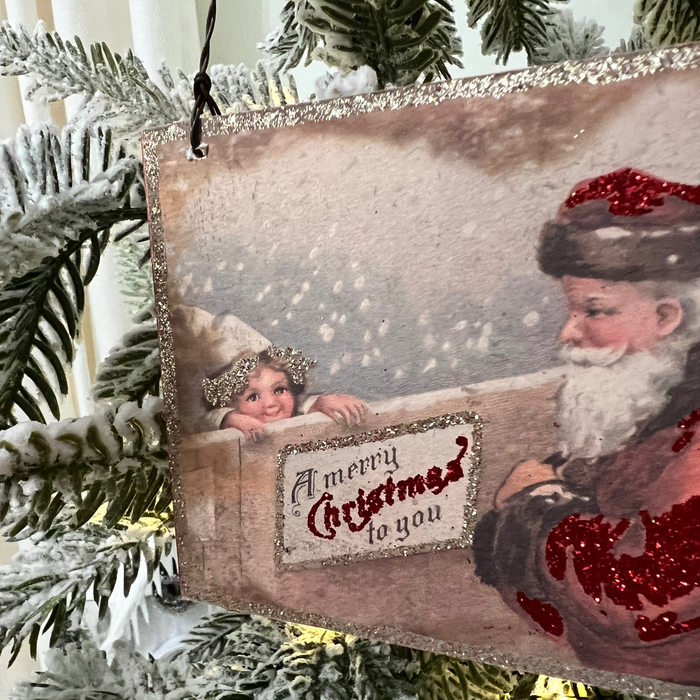 Closeup of Santa with Merry Christmas Sign