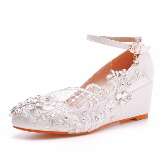 Elegant white wedge bridal sandals with lace detailing and floral embellishments for weddings